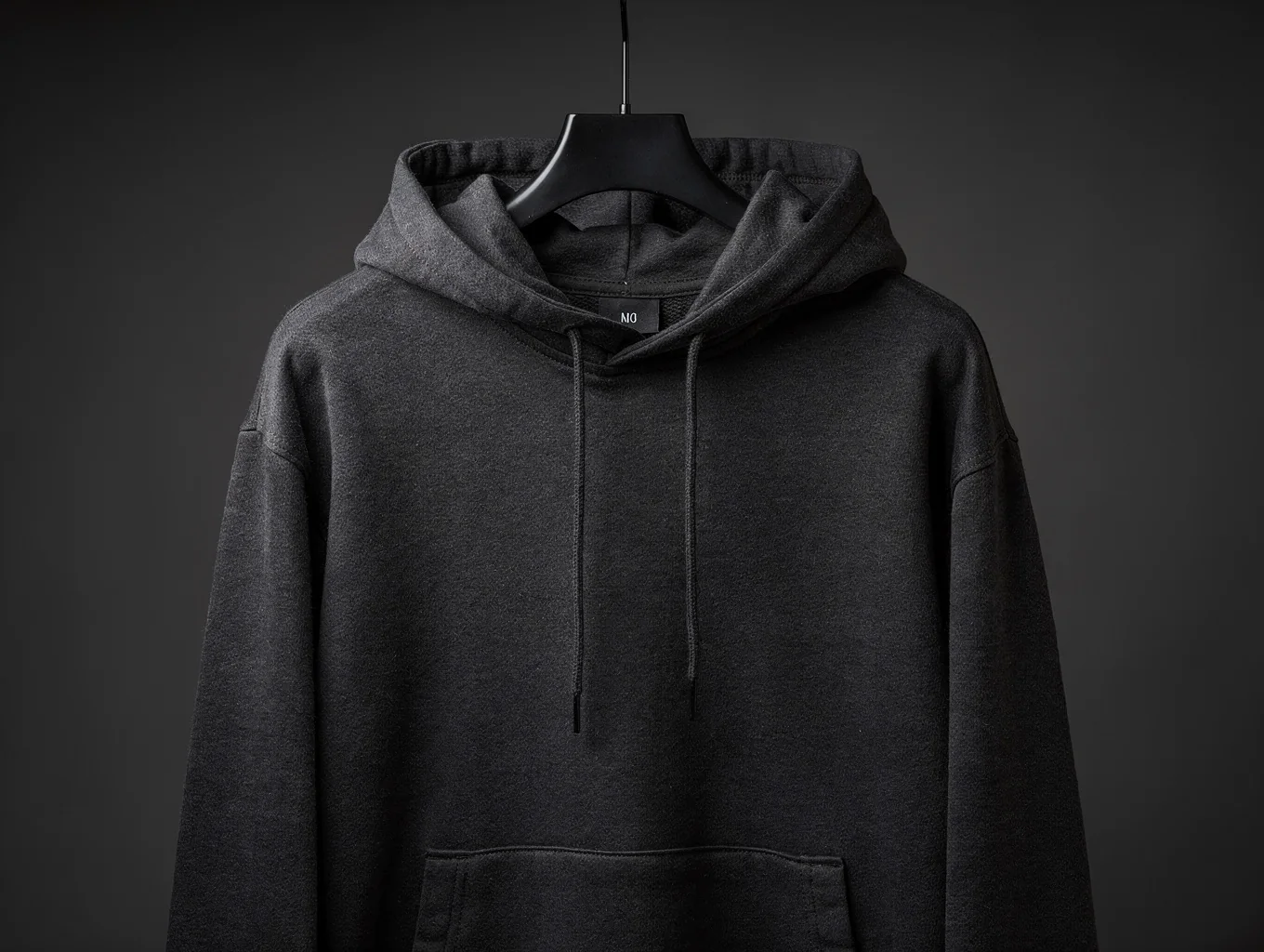 Studio heavyweight oversized black hoodie mockup on dark charcoal background